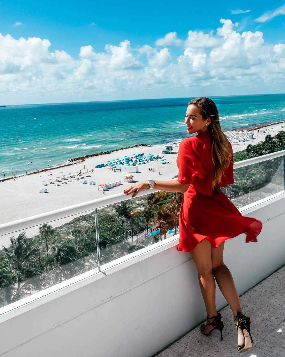 Isabella-at-Miami-Beach-on-balcony-wearing-red-dress