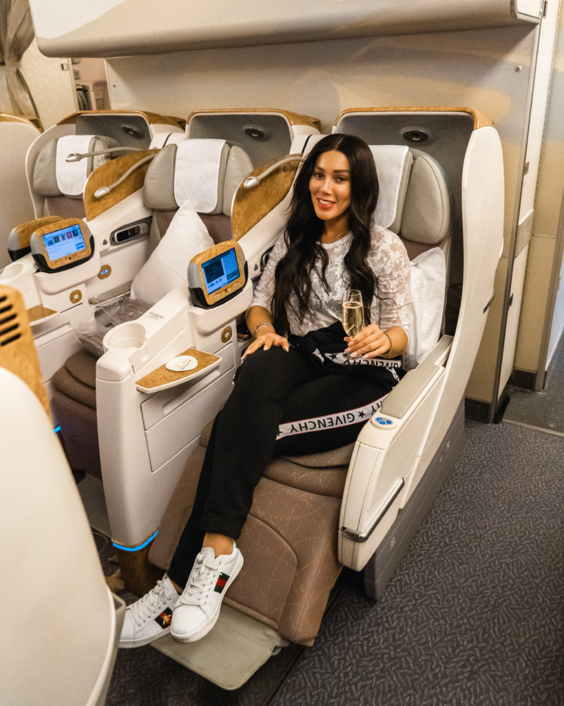 Isabella Garofanelli having a glass of champagne on Emirates air Business Class section
