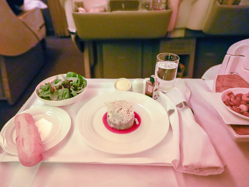 having dinner appetizer in Emirates business class section