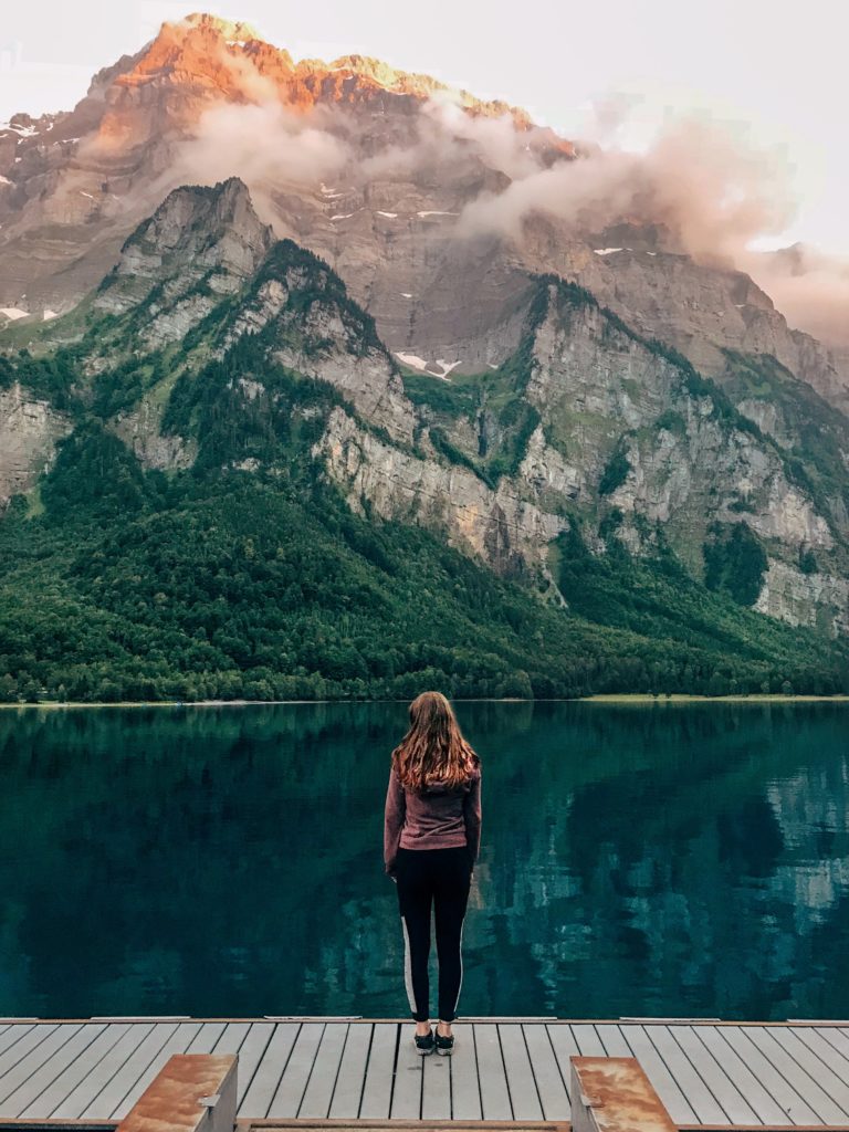 A girl staring out at a mountain
