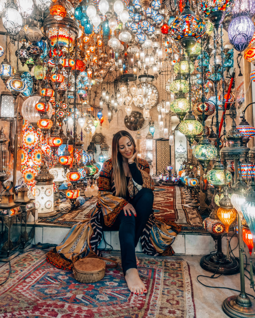 Isabella sitting in front of a lantern shop in Turkey
