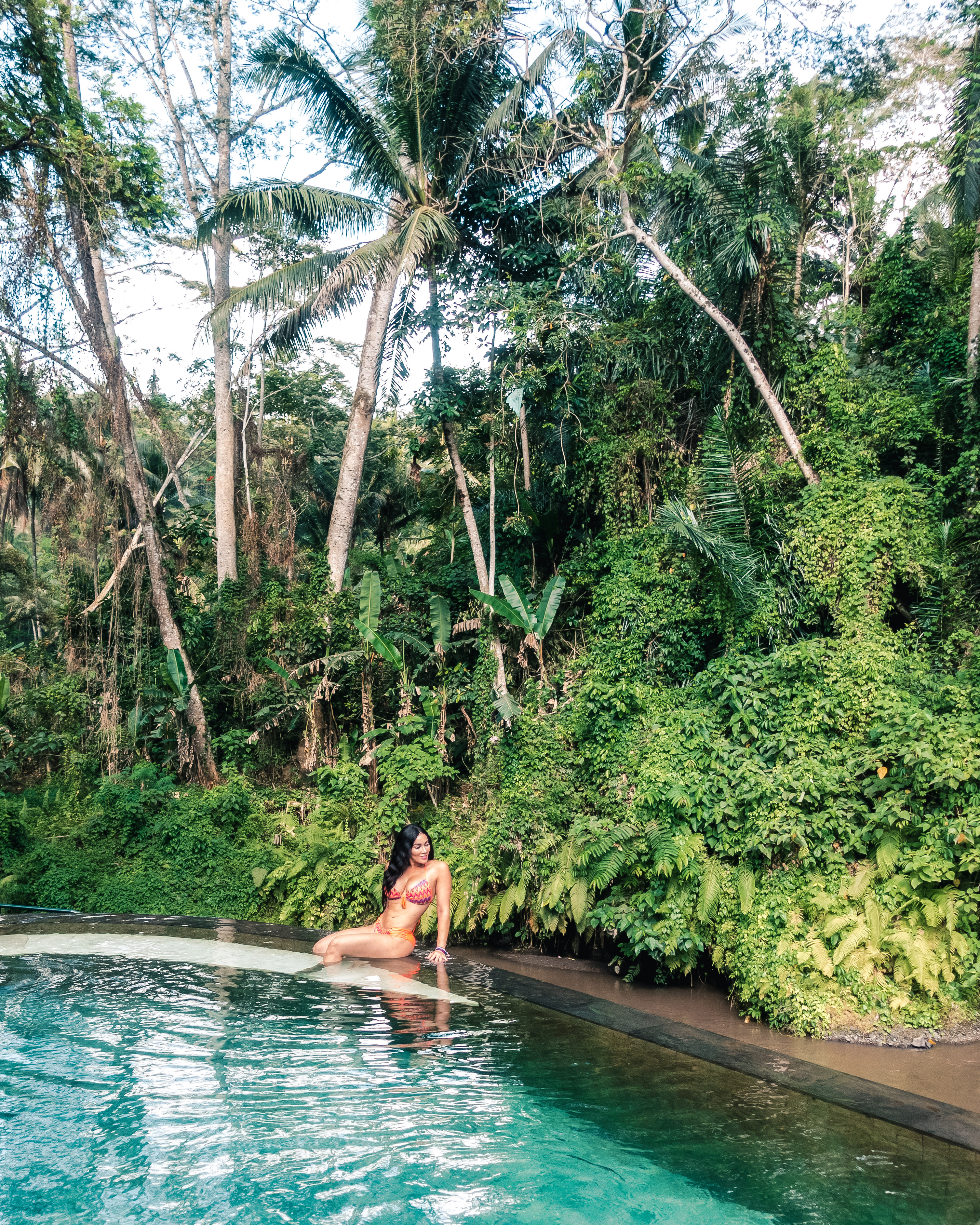 Isabella sitting by the pool in Four Seasons Sayan, Ubud
