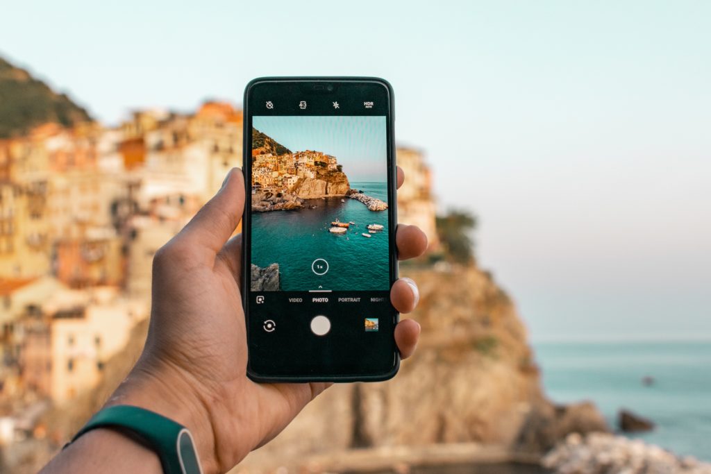 Smartphone user taking a photo of cliffs 