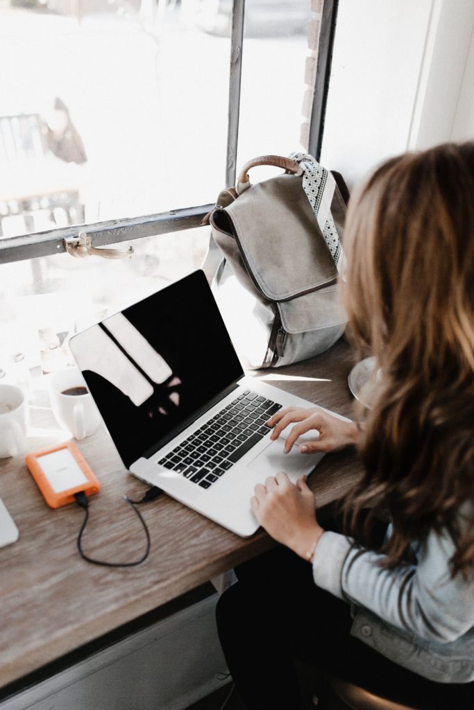 Woman blogging on a laptop