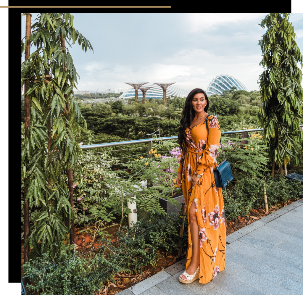 Isabella standing in front of the Gardens by the Bay in a floral yellow dress