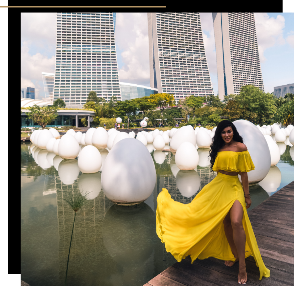 Isabella in a yellow co-ord standing in front of the Marina Bay Sands building