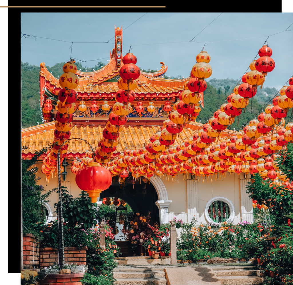 A temple in Penang with red and yellow lanterns