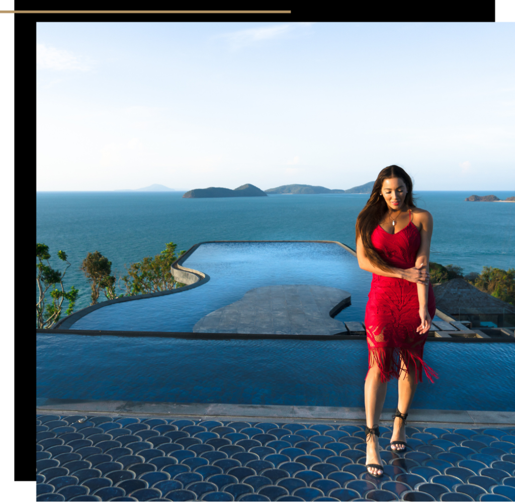 Isabella in a red dress holding her arm at Baba's Nest, Phuket, Thailand
