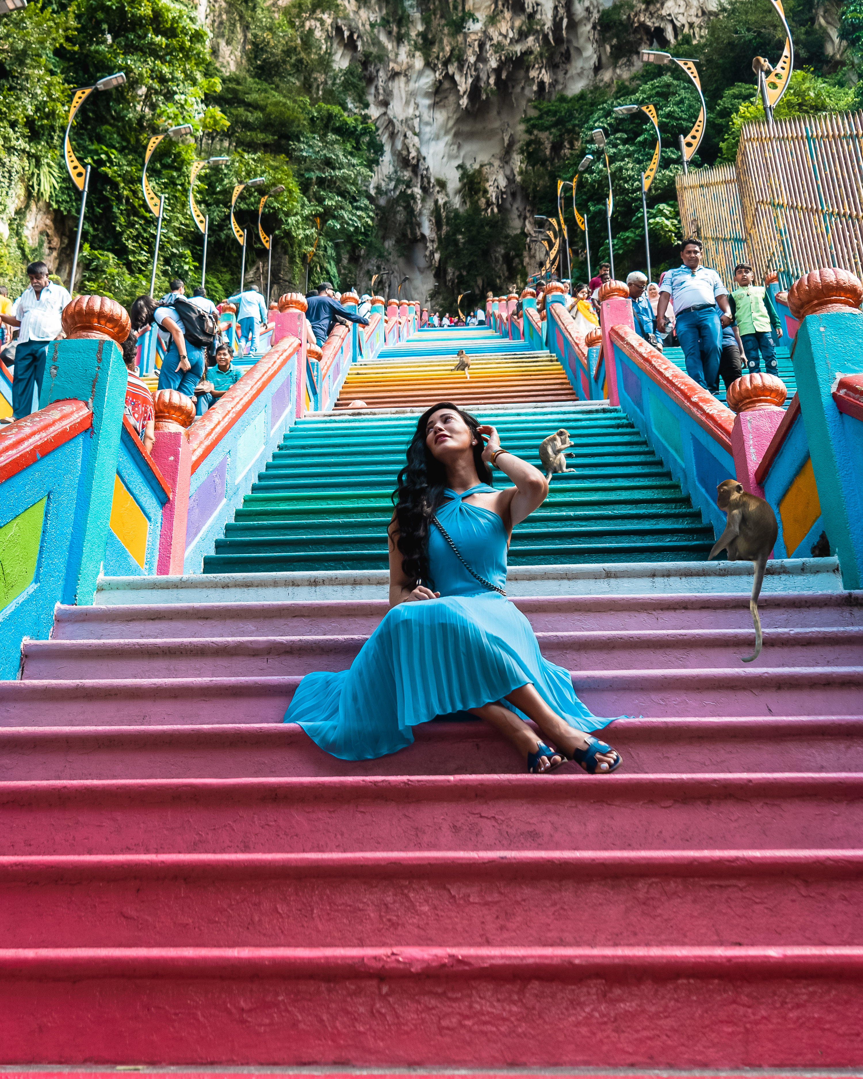Isabella sitting on the steps at the Batu Caves in Kuala Lumpur