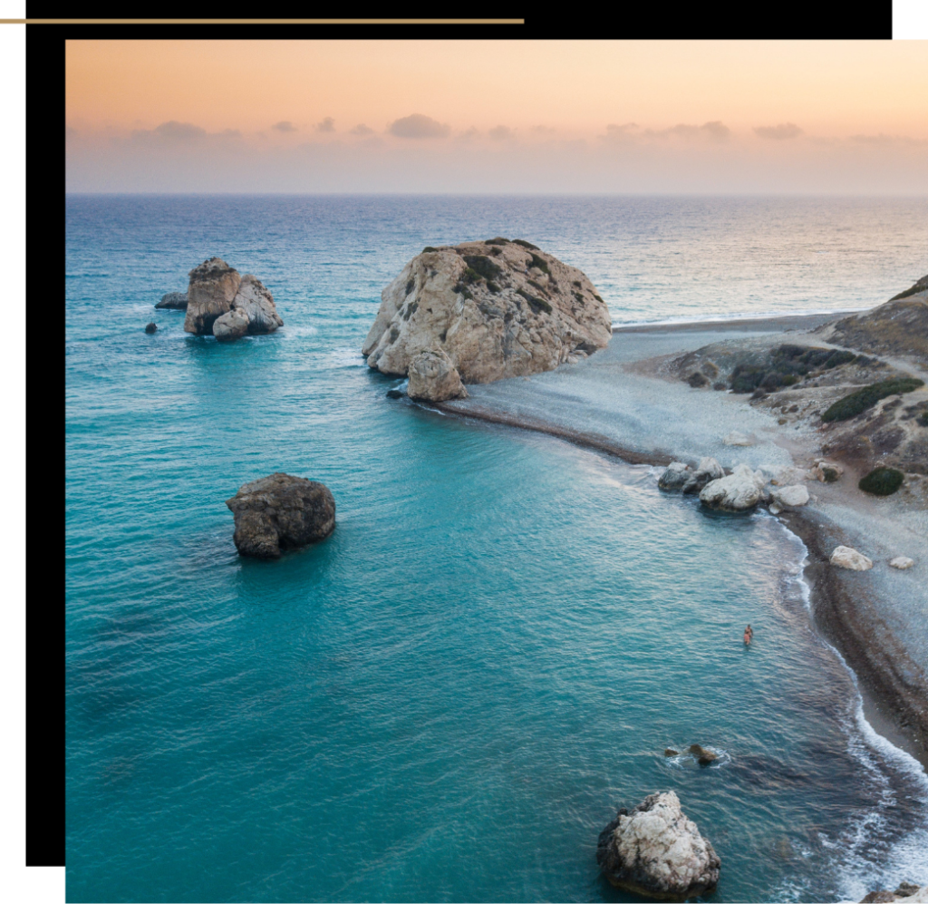 A rocky beach and blue sea at sunset in Cyprus, one of the best winter sun destinations in Europe