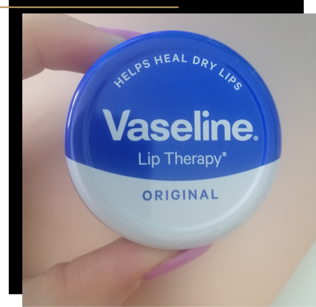 Woman holding Vaseline original lip therapy pot 
