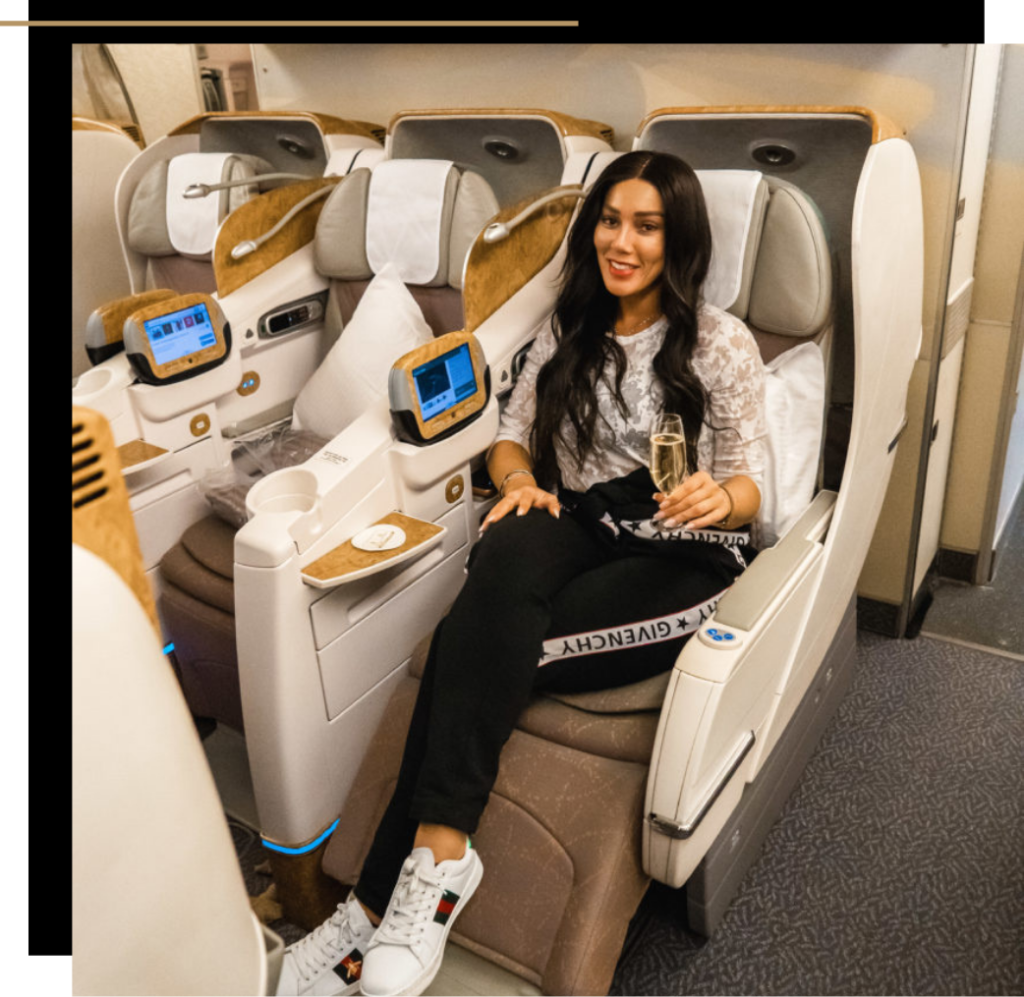 Isabella in a business class seat on a plane 