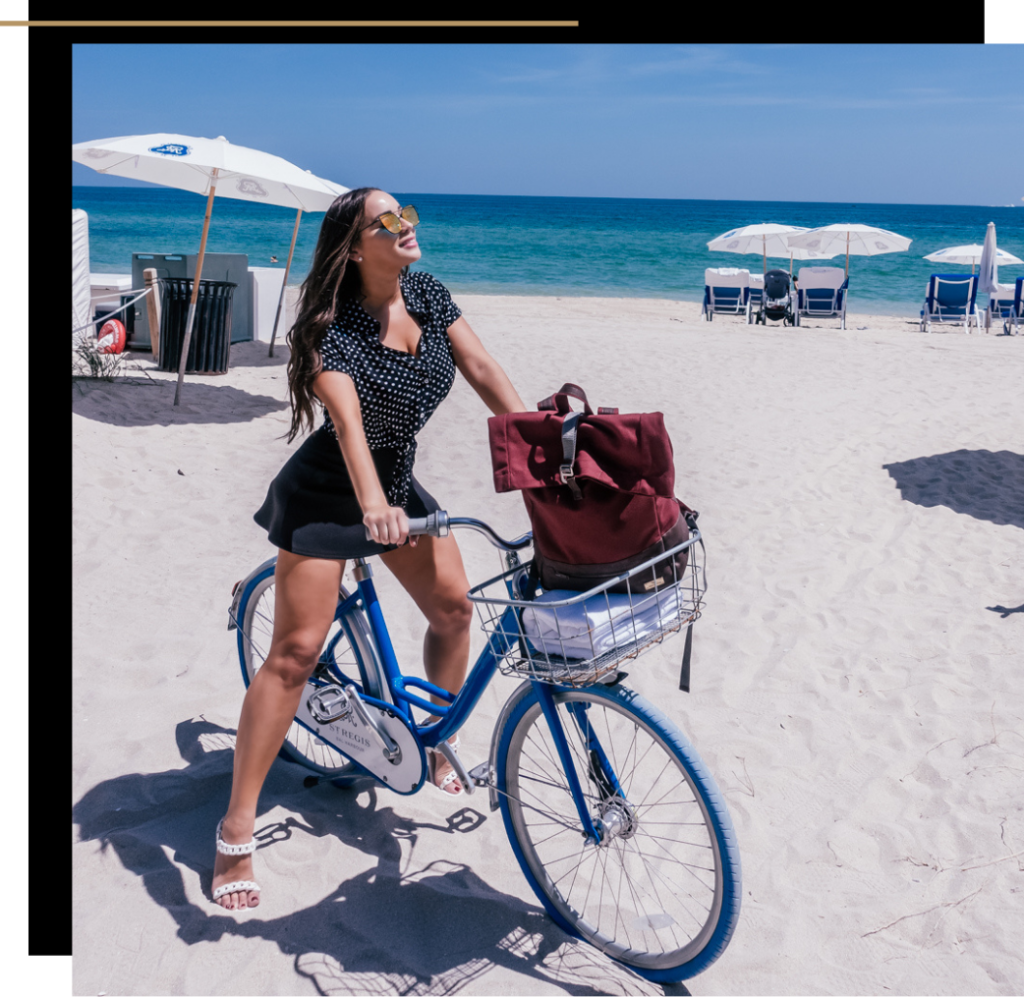 Isabella on a bike on the beach at the St Regis Bal Harbour in Miami