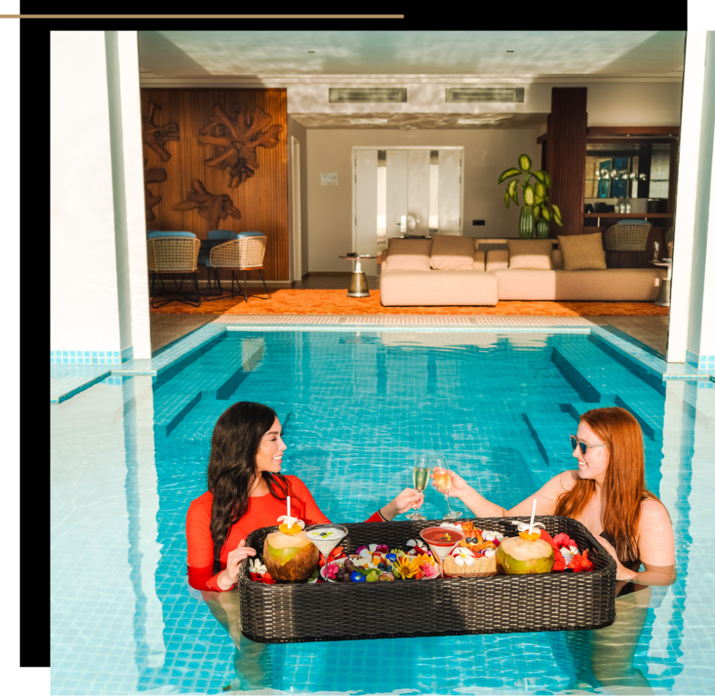 Isabella and Hannah toasting over a floating breakfast in the pool at the Presidential Villa at Emerald Maldives Resort & Spa