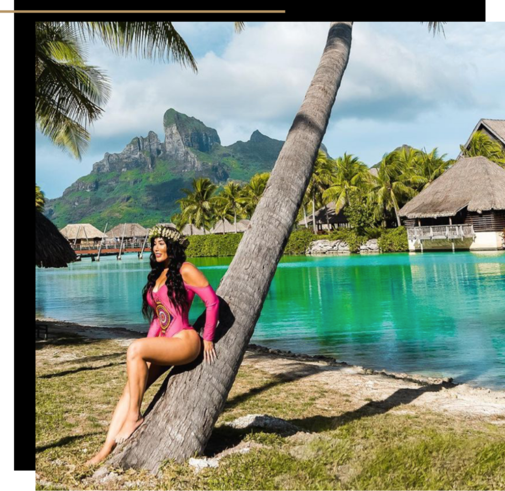 Isabella leaning against a palm tree at the Four Seasons Resort Bora Bora 